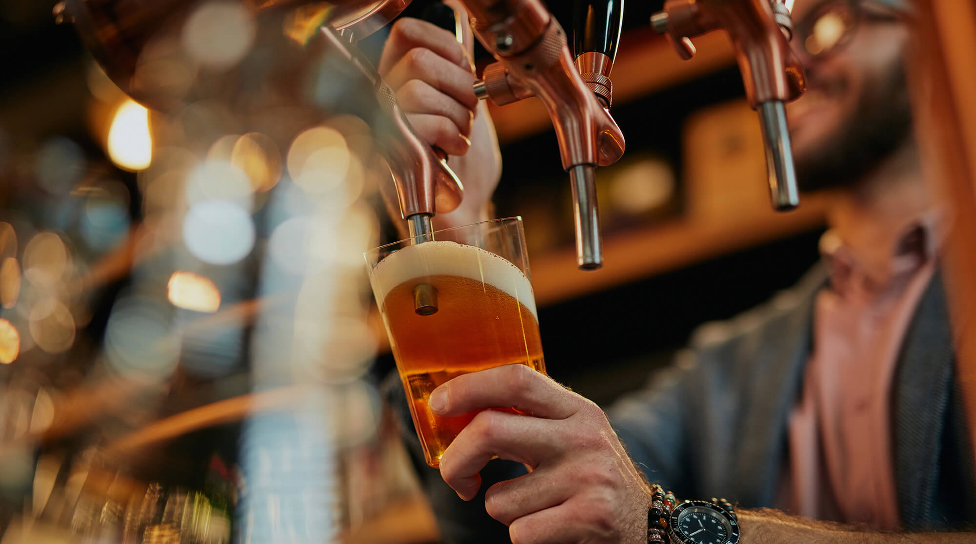 Draft beer being poured into a glass
