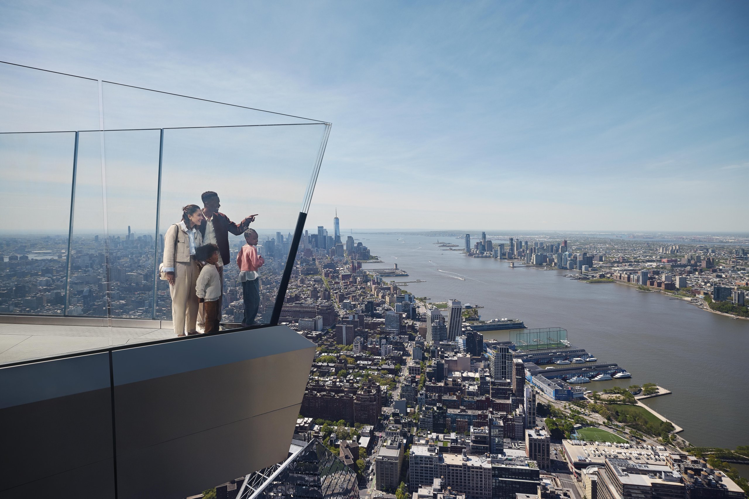 family of four on the skydeck looking out at city skyline