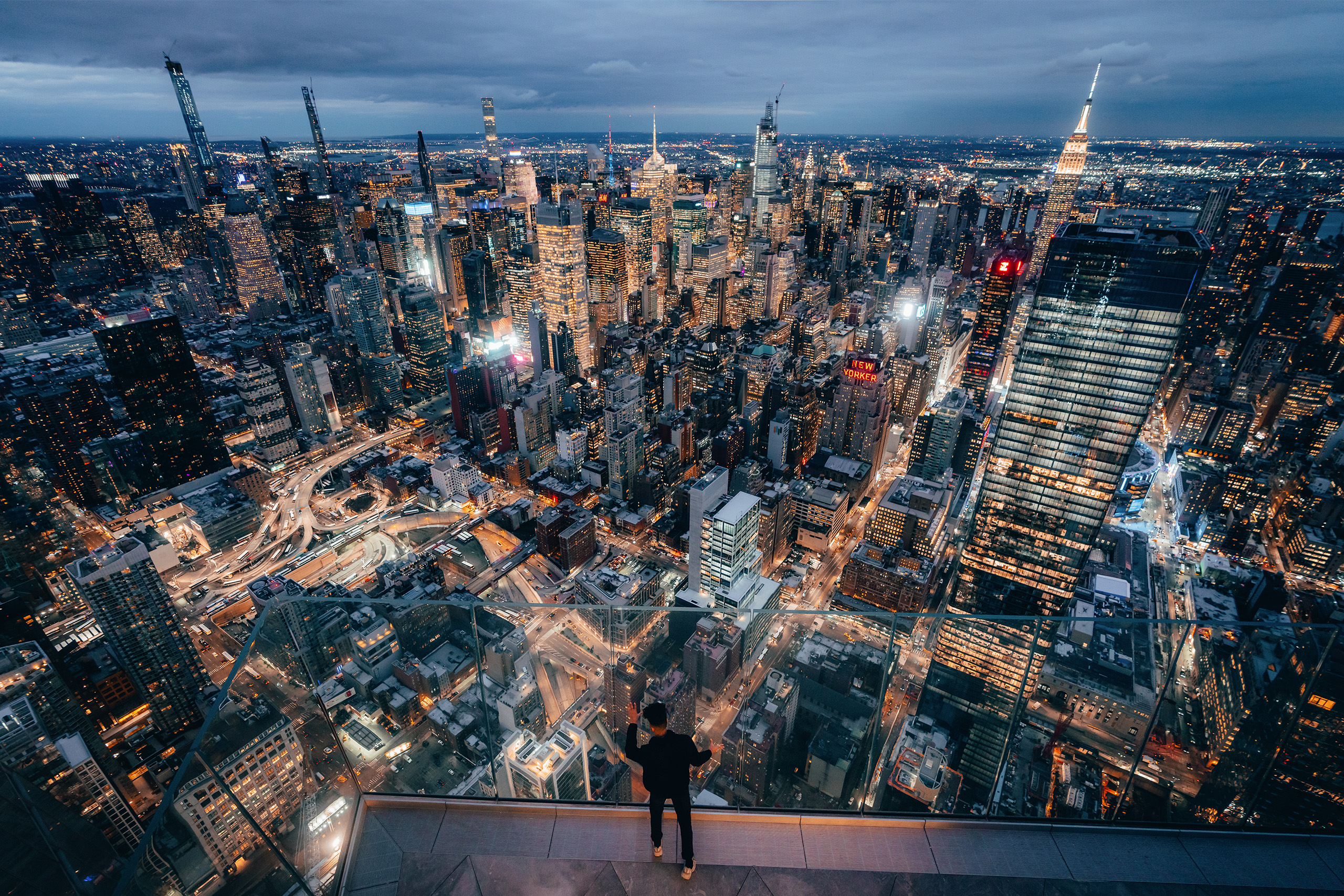 Man looking at NYC Skyline during the evening at The Edge NYC